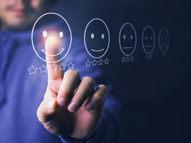 Brand-Expression-Experience Person selecting a floating emoji with a star rating