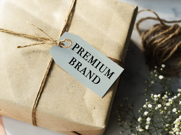 Box wrapped in brown paper wrapping, tied in brown string, with a tag labelled "premium brand"