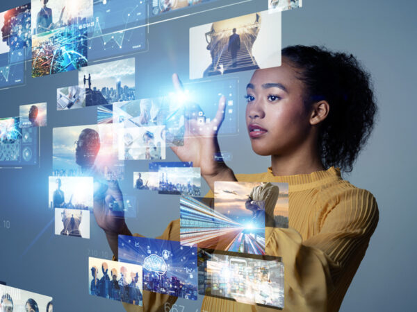 Woman looking at a wall of floating images, tapping one